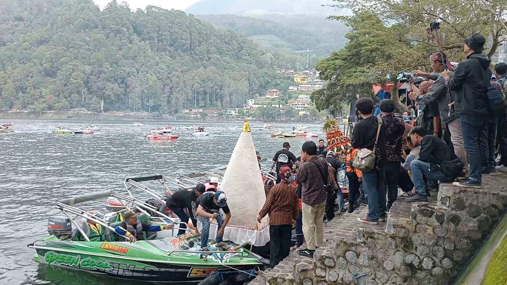 Dua tumpeng raksasa diarak keliling dan ditengelamkan di tengah telaga. IDN Times/ Riyanto.