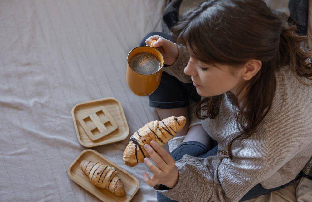Ilustrasi wanita makan roti di kamar (freepik.com/pvproductions)