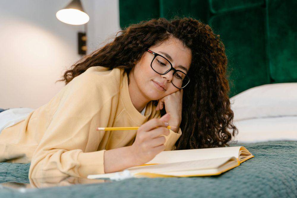 https://www.pexels.com/photo/photo-of-woman-writing-on-notebook-3059691/