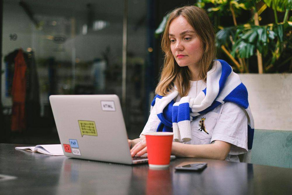 ilustrasi seorang wanita yang fokus bekerja menggunakan laptop (pexels.com/Anna Shvets)