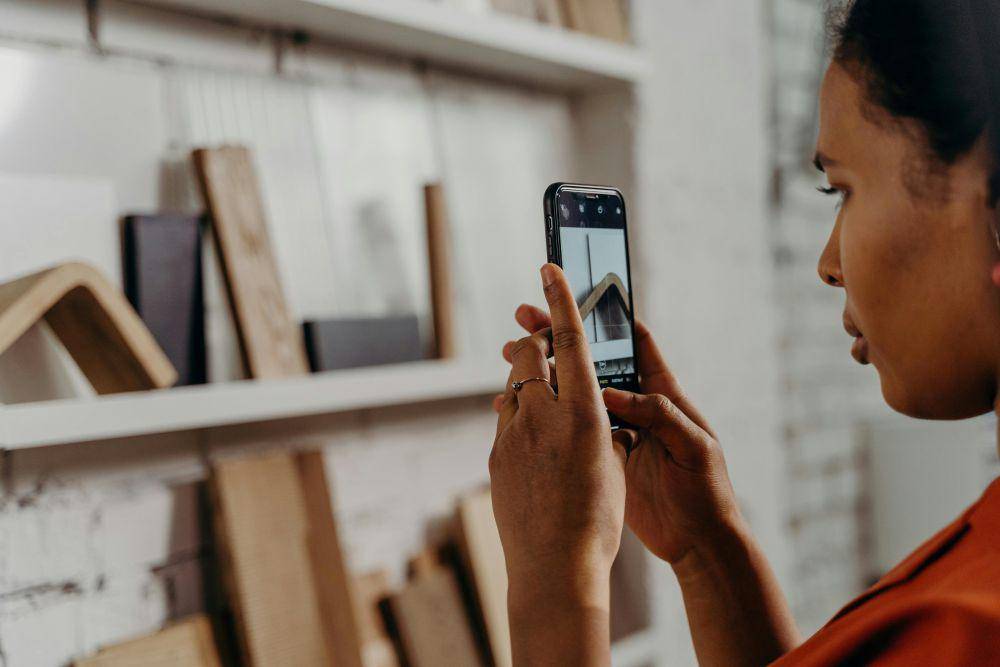 Ilustrasi wanita memotret menggunakan Iphone (pexels.com/cottonbro studio)