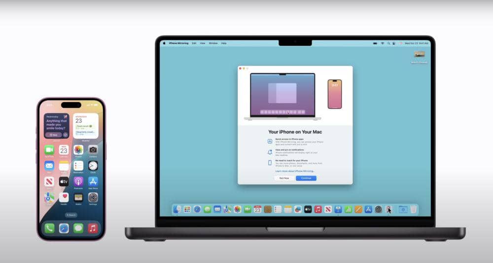 Sebuah MacBook menampilkan layar pengaturan koneksi dengan iPhone yang diletakkan di sebelahnya, menunjukkan integrasi antar perangkat Apple.