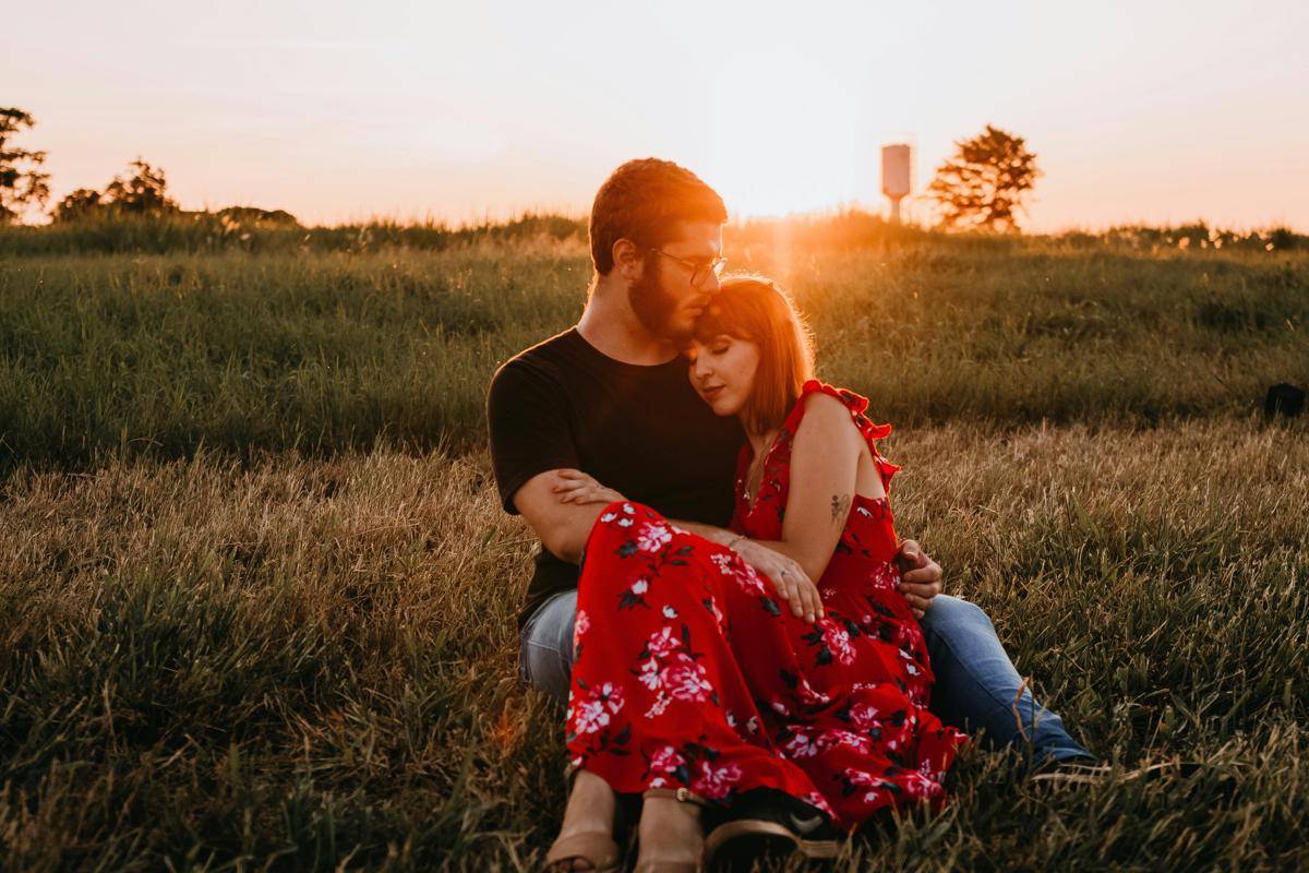 Photo by Diego Rezende: https://www.pexels.com/photo/man-in-black-crew-neck-t-shirt-sitting-on-grass-field-beside-woman-in-red-floral-dress-3687688/