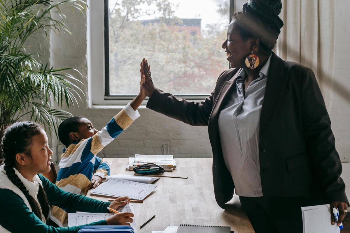Photo by Katerina Holmes: https://www.pexels.com/photo/cheerful-black-teacher-with-diverse-schoolkids-5905918/
