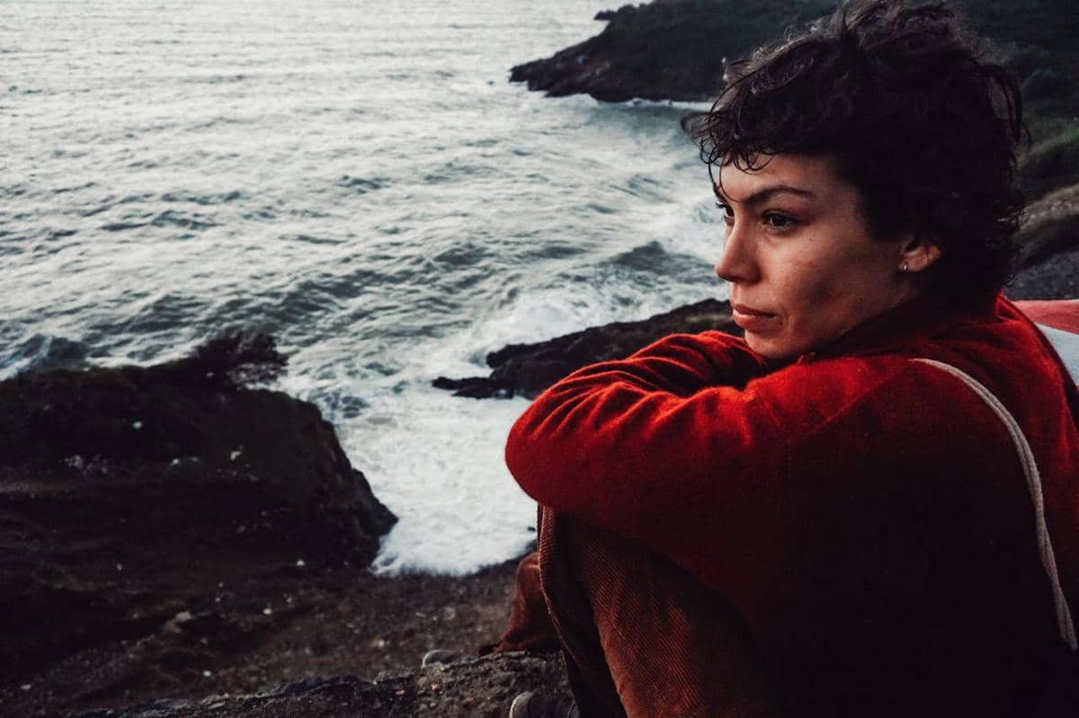 ilustrasi seseorang di bebatuan pantai