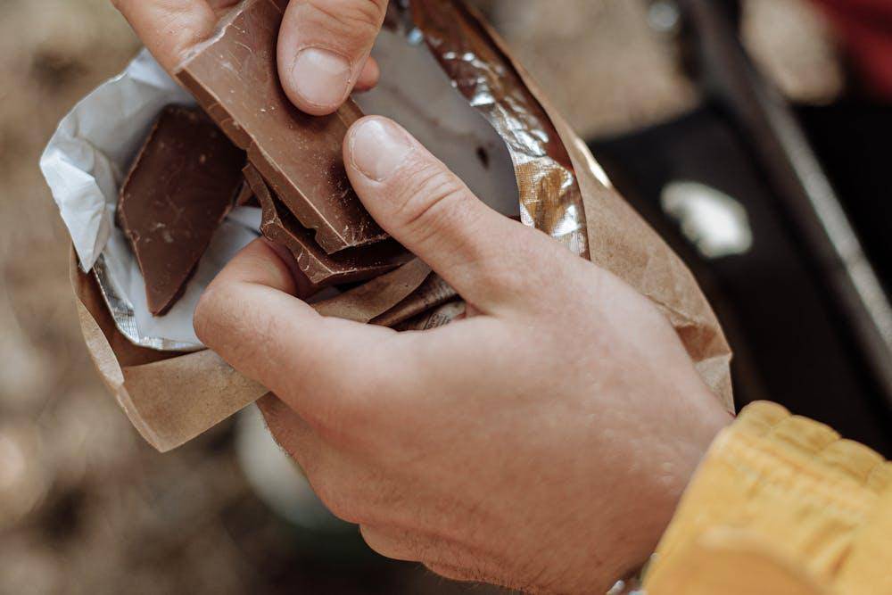 ilustrasi pendaki sedang menikmati cokelat (pexels.com/Thirdman)