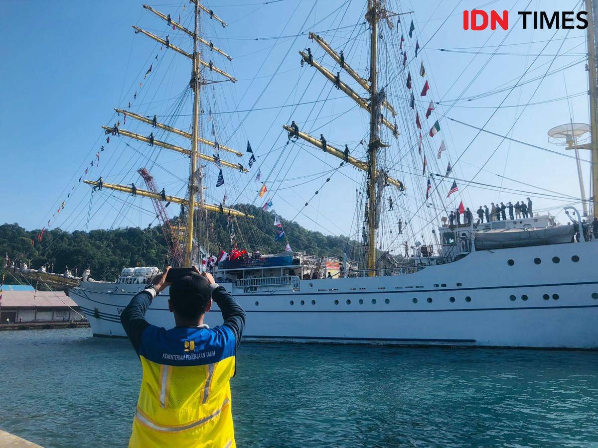 Seorang petugas pelabuan mengabadikan momen kedatangan KRI Bima Suci di Pelabuhan Teluk Bayur (Foto: IDN Times/Halbert Caniago)