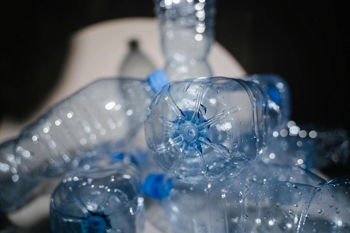 Ilustrasi botol bekas menumpuk. (pexels.com/MART PRODUCTION)