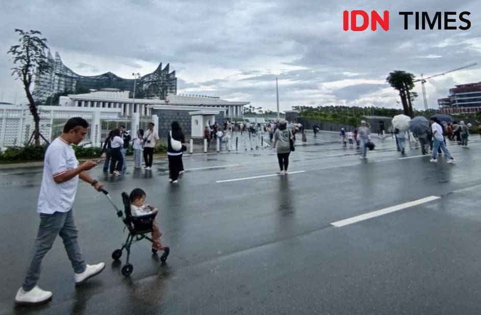 Pengunjung melintas di depan Istana Negara KIPP IKN.