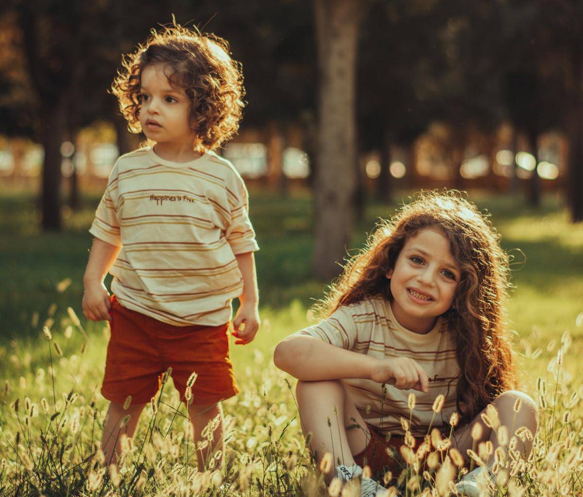 gambar dua anak bermain di padang rumput (unsplash.com/muhamad kamaran)