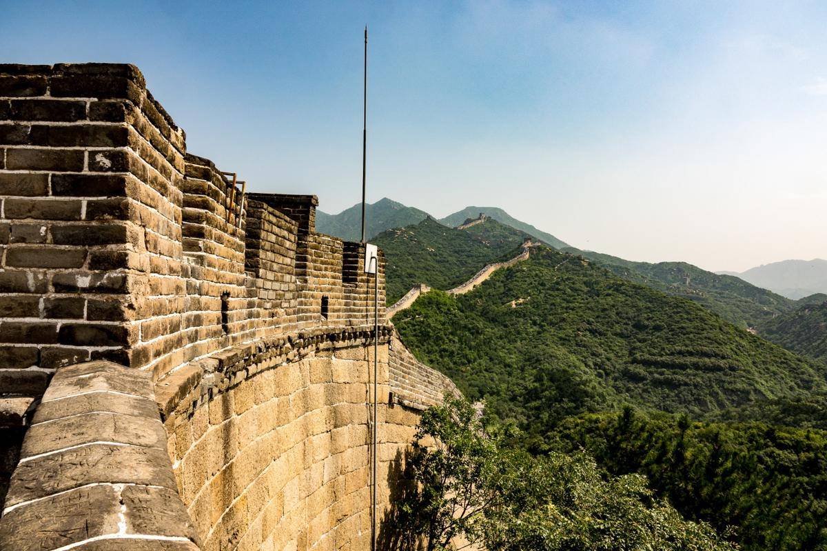 high-angle-closeup-shot-famous-great-wall-china-surrounded-by-green-trees-summer.jpg