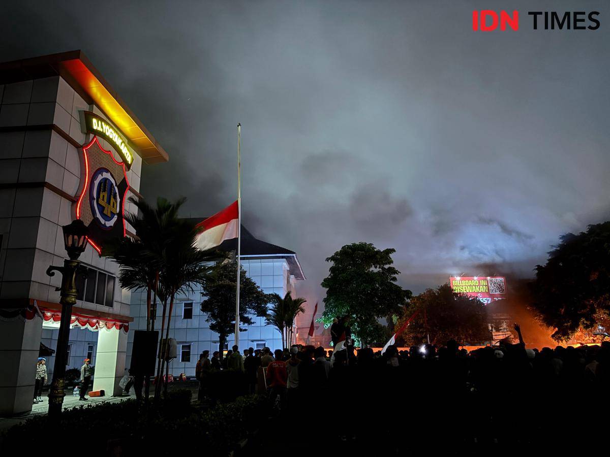 Bendera setengah tiang dikibarkan oleh massa aksi demonstran di halaman Mapolda Daerah Istimewa Yogyakarta, Jumat (29/8/2025).
