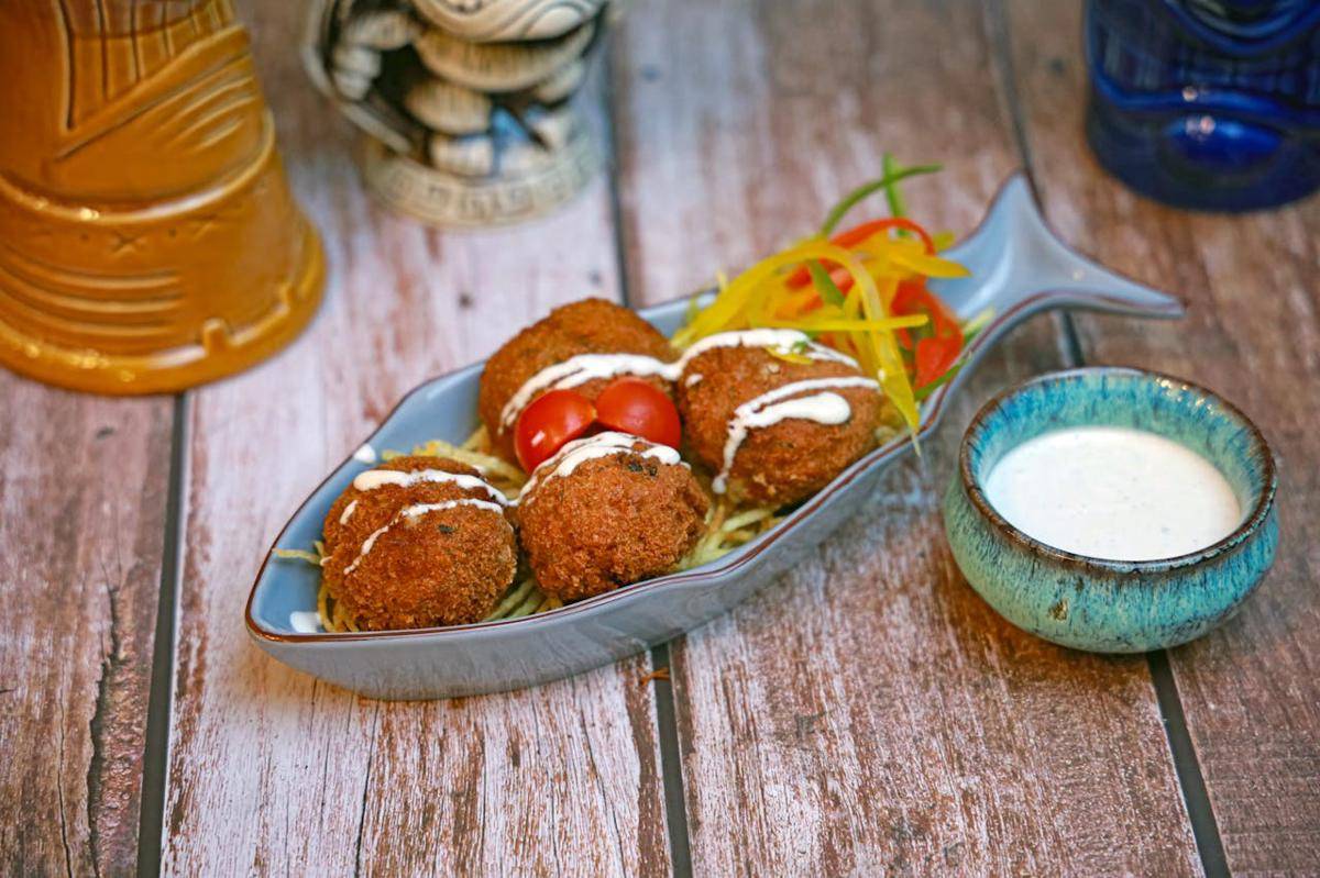 ilustrasi kroket kentang isi tongkol pedas yang disajikan dengan saus pelengkap 
