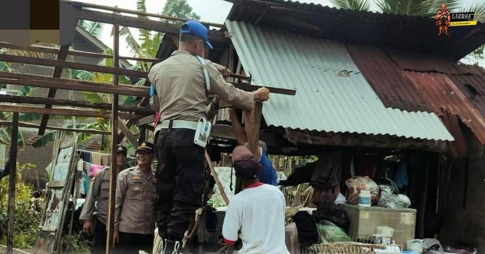 Personel Polsek Talang Kelapa saat membantu memperbaiki rumah warga yang diterjang puting beliung. (Dok. Polsek Talang Kelapa)
