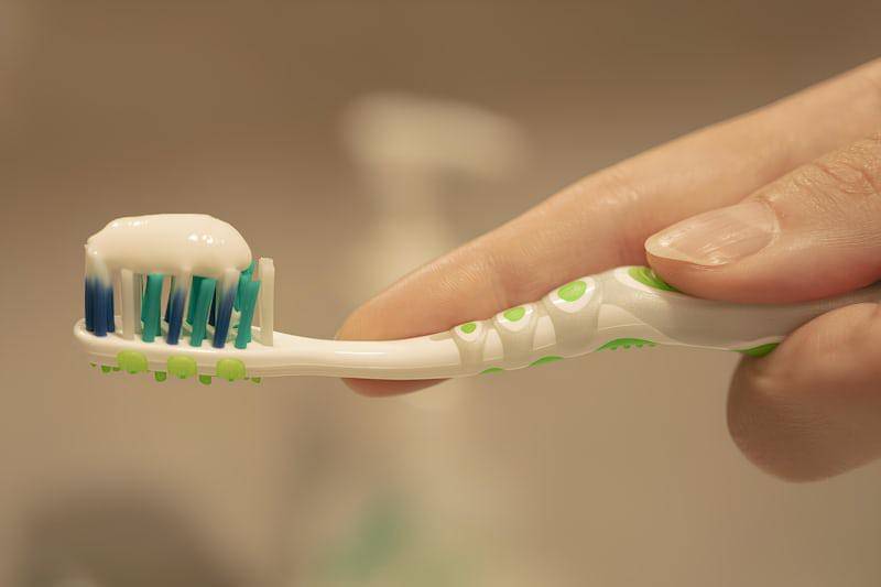https://unsplash.com/photos/a-person-is-holding-a-toothbrush-with-toothpaste-on-it-Tin0iDzvfDE