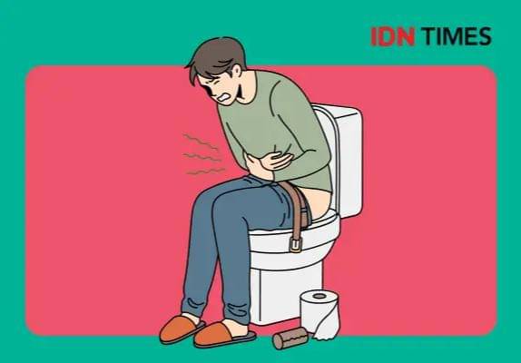 Seorang laki-laki duduk di toilet, buang air besar.