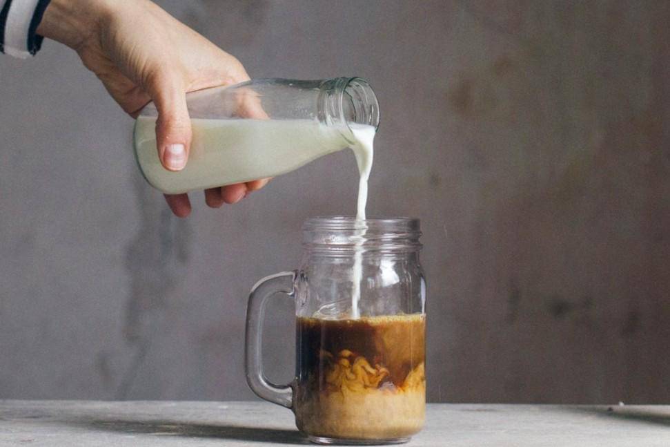 Potret menuangkan krimer ke dalam kopi