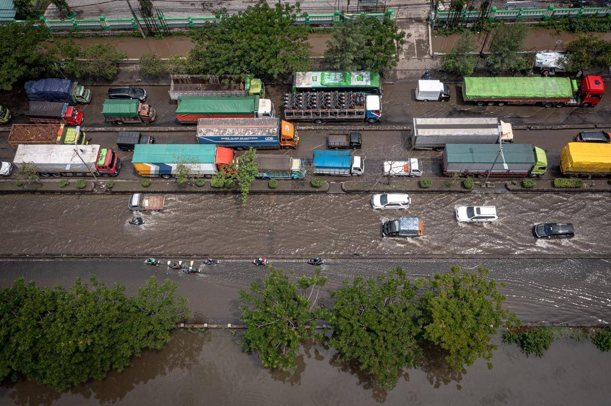 Foto udara sejumlah kendaraan melaju perlahan melewati banjir di jalur utama pantura Semarang-Surabaya, Jalan Kaligawe Raya, Semarang, Jawa Tengah, Rabu (22/10/2025). (ANTARA FOTO/Aji Styawan)