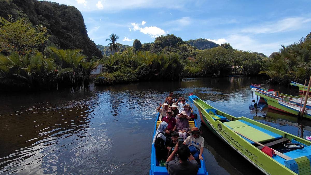Wisatawan menyusuri Sungai Pute dengan perahu listrik di kawasan karst Rammang-Rammang, Kabupaten Maros, Sulawesi Selatan. (IDN Times/Aan Pranata)