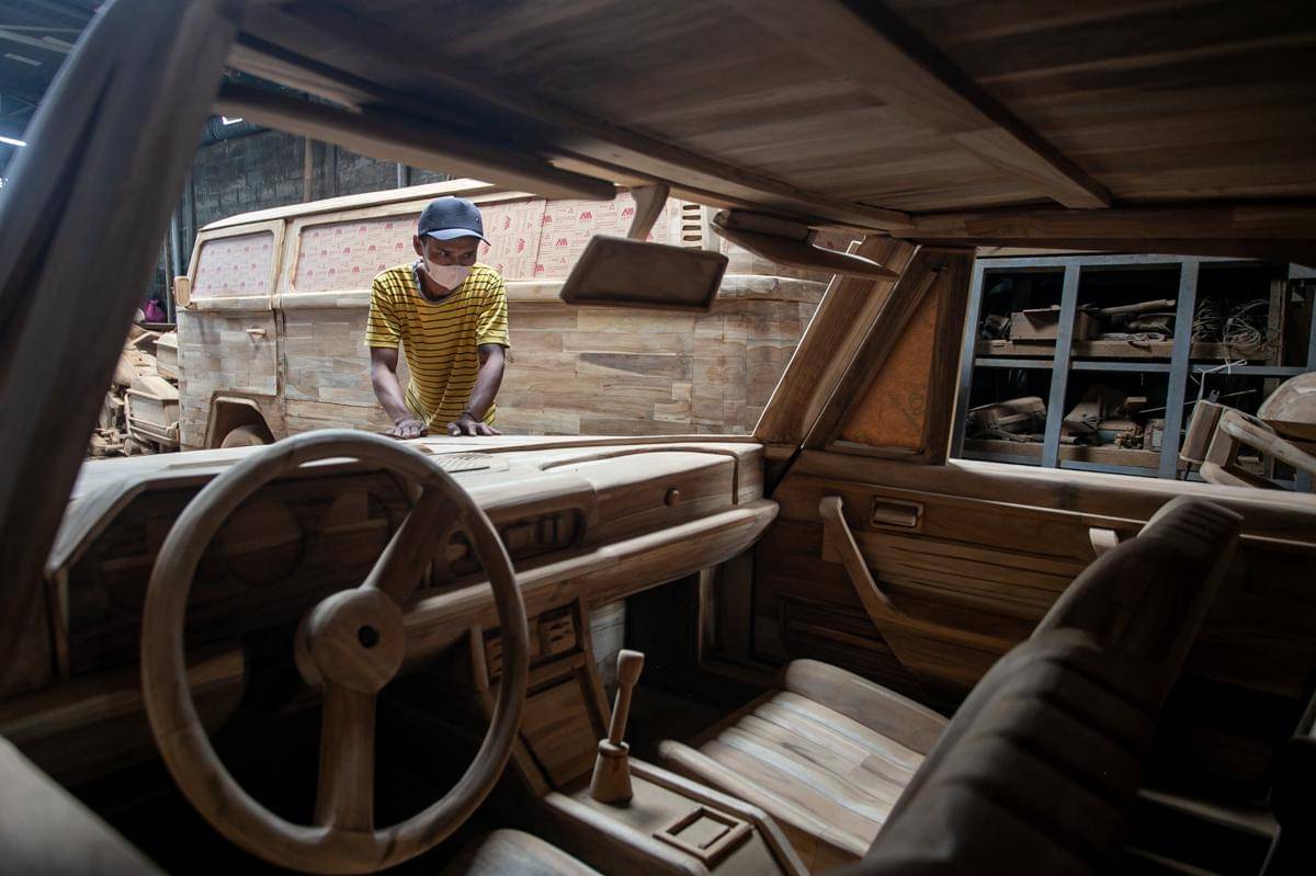 Perajin menyelesaikan proses akhir pembuatan kerajinan replika mobil dan motor dari kayu di Tetap Jaya Wood Art, Mojosongo, Boyolali, Jawa Tengah. (ANTARA FOTO/Mohammad Ayudha)