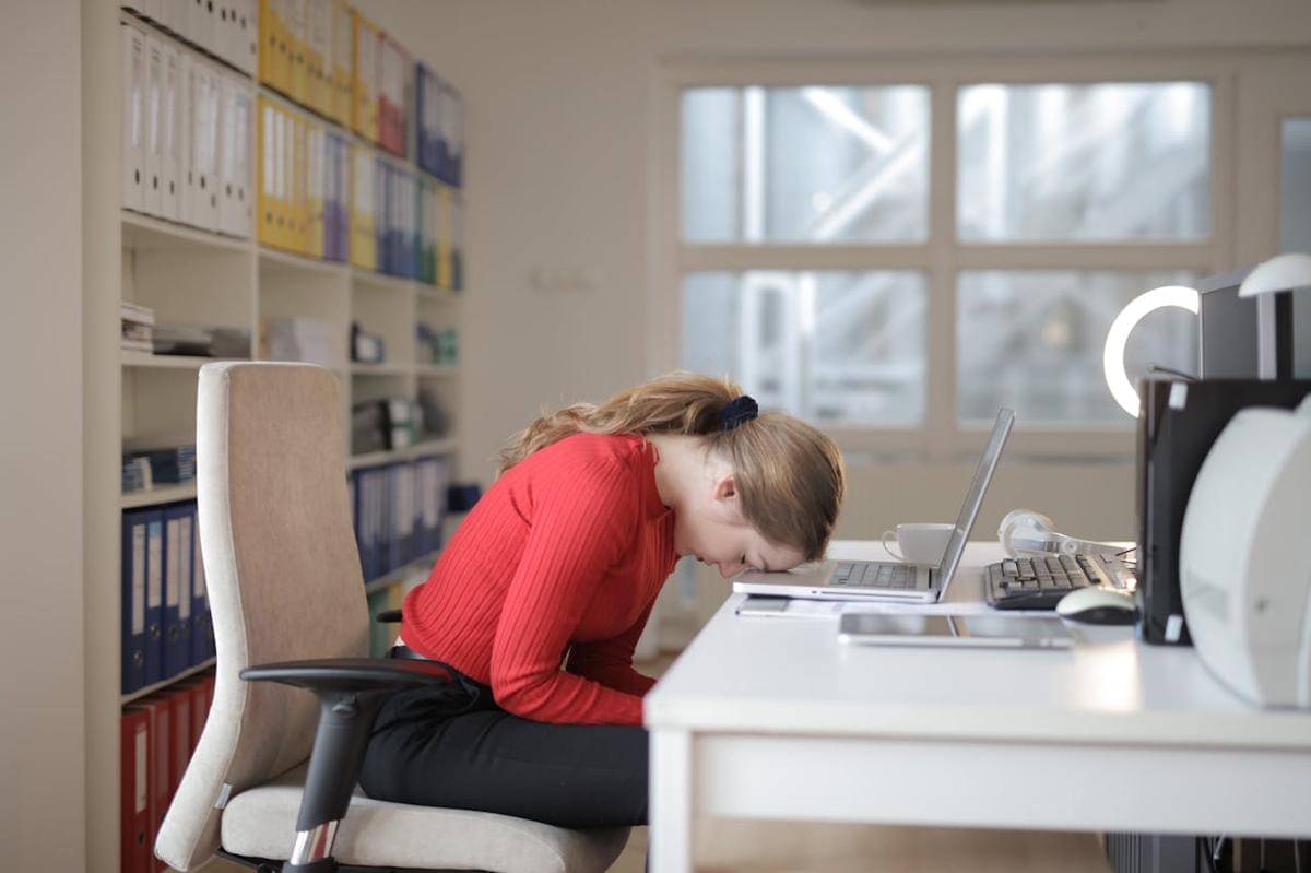 https://www.pexels.com/photo/woman-in-red-long-sleeve-shirt-sitting-on-chair-while-leaning-on-laptop-3791134/