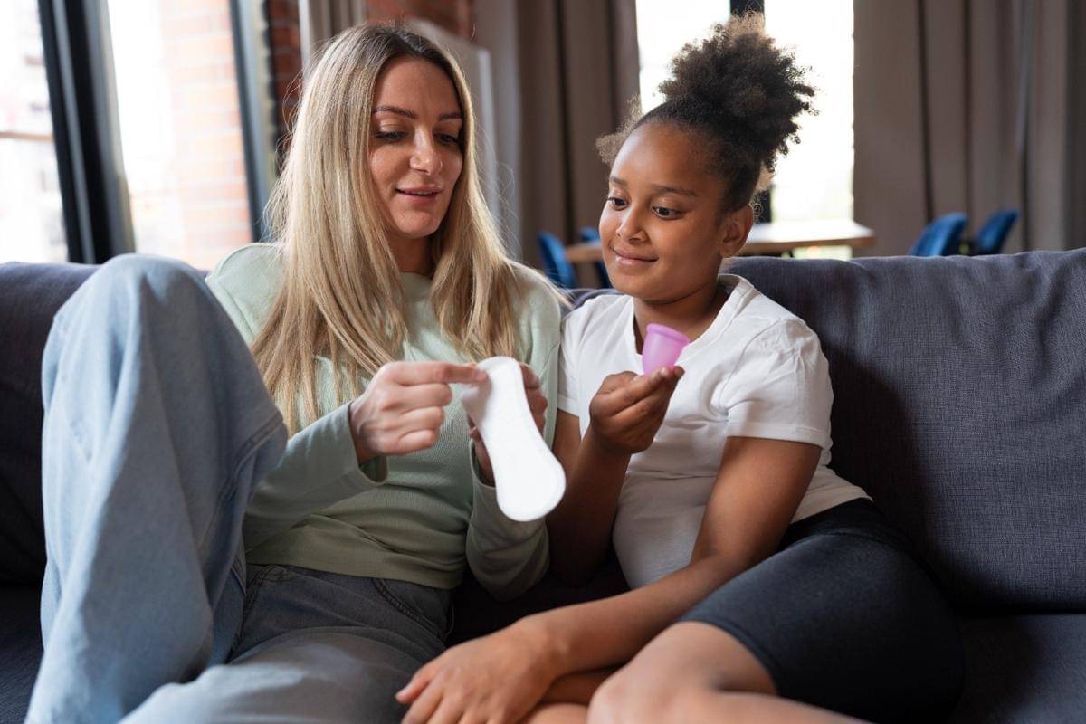 ilustrasi seorang ibu mengajari anak cara memakai produk menstruasi