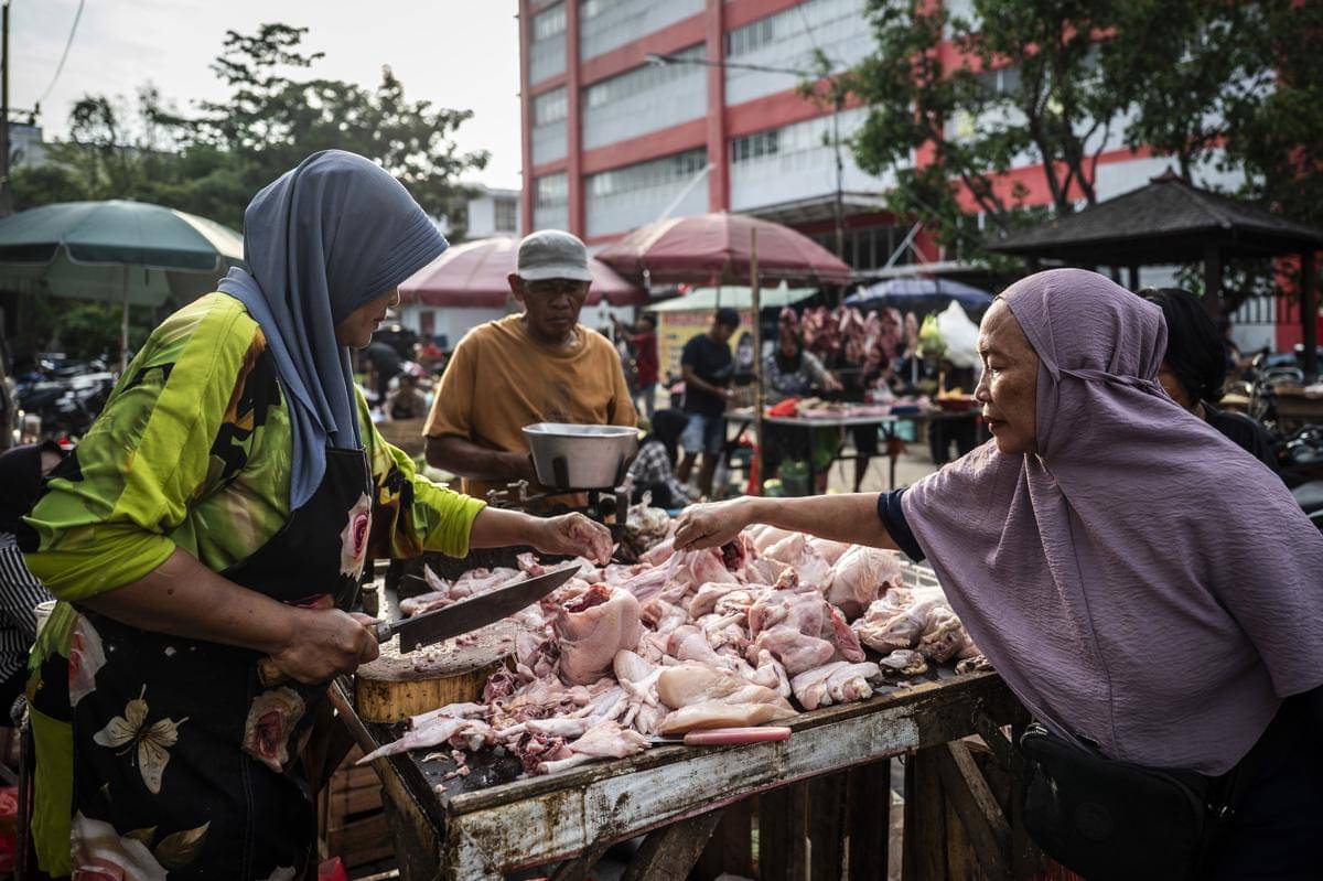 Pedagang (kiri) melayani warga yang berbelanja daging ayam ras di Pasar Johar, Semarang, Jawa Tengah. (ANTARA FOTO/Aprillio Akbar)
