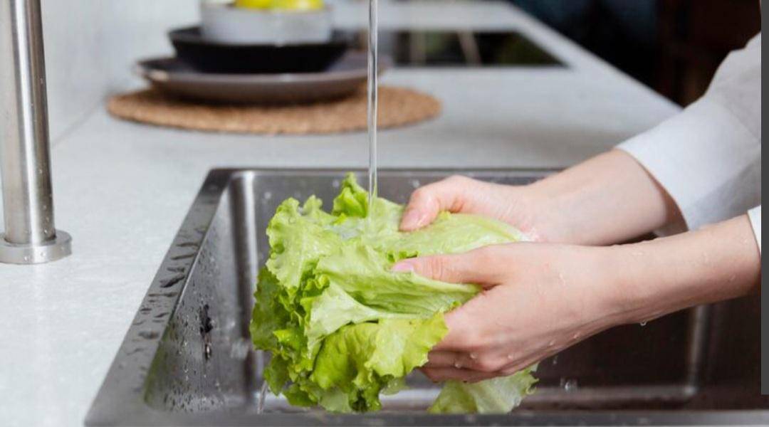 ilustrasi bilas selada di bawah air mengalir