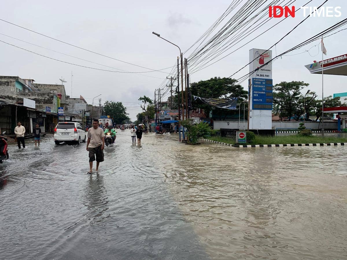 Air masih menggenangi jalan di Kecamatan Marelan, Jumat (28/11/2025) (IDN Times/Doni Hermawan)