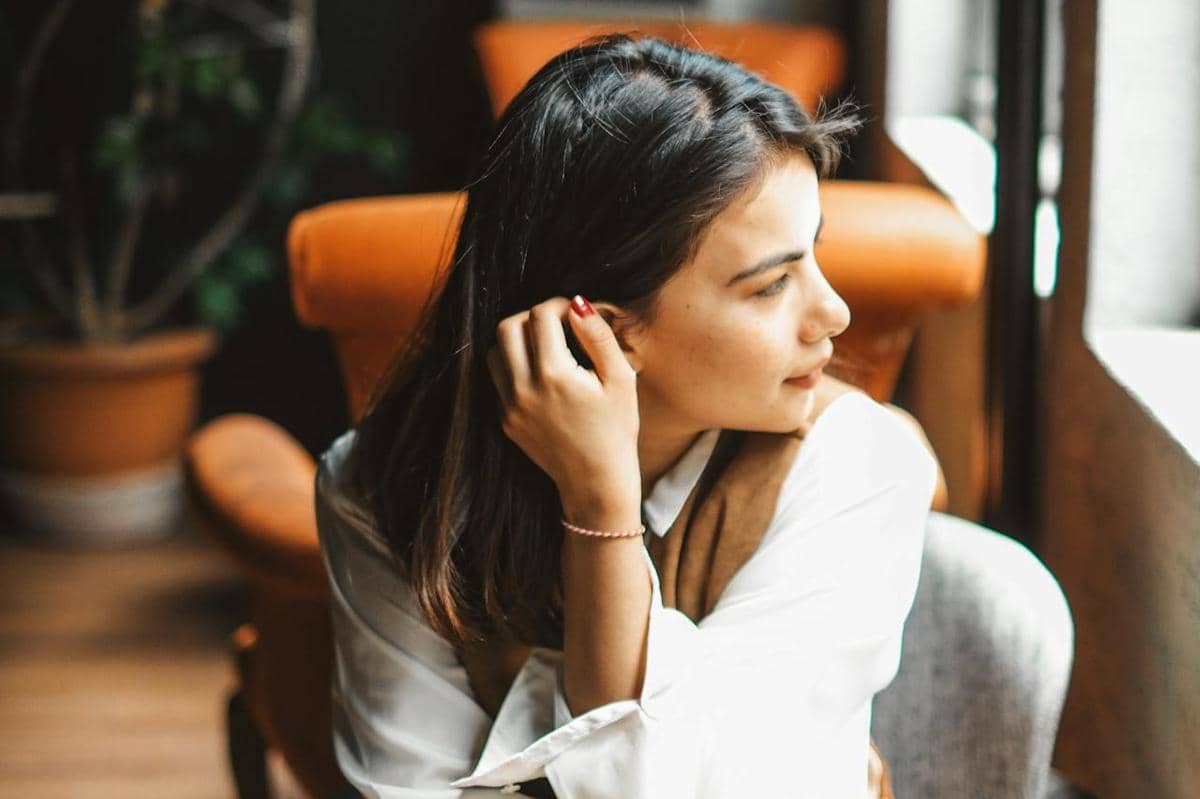 Wanita sedang melihat ke luar jendela.