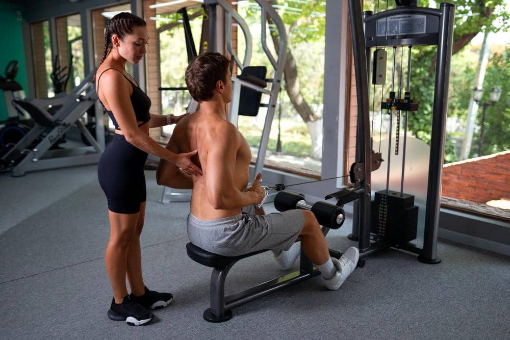 Latihan dengan seated row machine di gym.