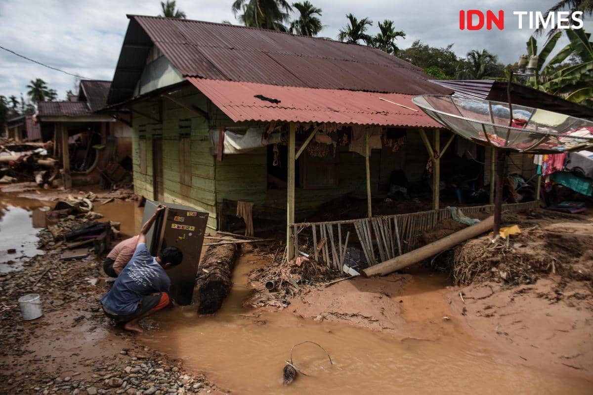 Warga mulai membersihkan rumah mereka pasca banjir menerjang Tapanuli Tengah, Kamis (18/12/2025). (IDN Times/Prayugo Utomo)