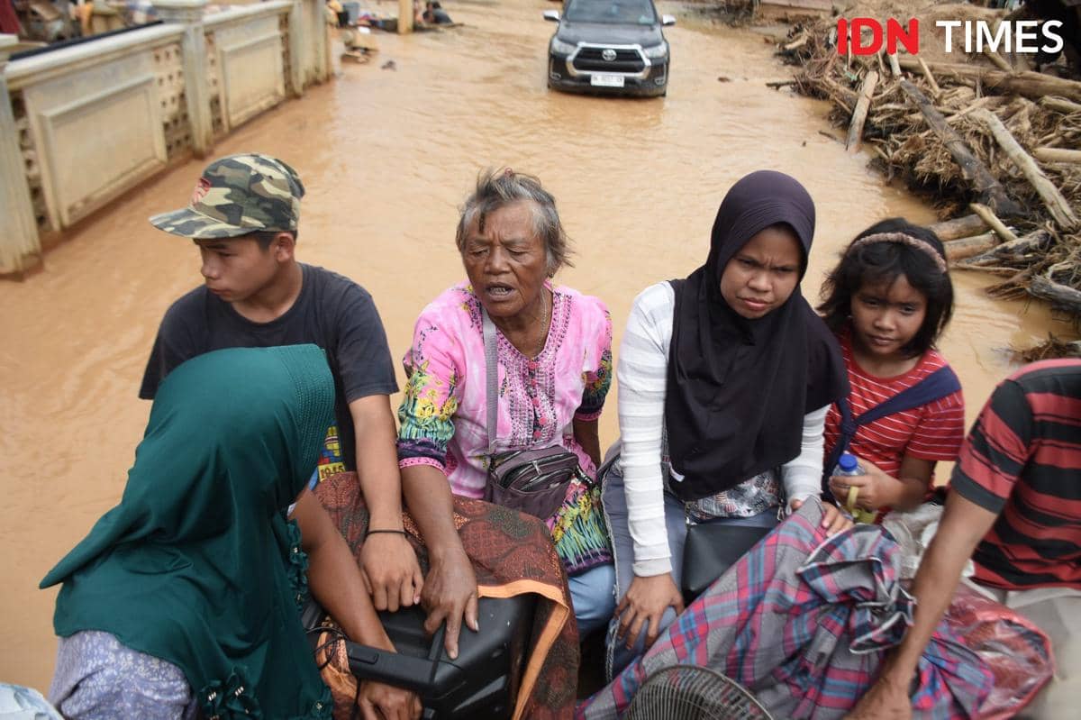 Warga menumpang mobil kabin ganda berpenggerak empat roda saat hendak ke luar dari kawasan Desa Hutanobolon, Kecamatan Tukka, Kabupaten Tapanuli Tengah, Jumat (19/12/2025). (IDN Times/Prayugo Utomo)