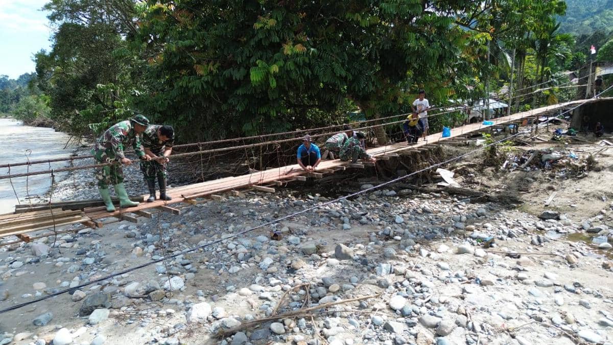 Prajurit TNI AD dari Babinsa Posramil Darul Hasanah bersama warga berhasil memperbaiki jembatan gantung di Desa Buntul Kendawi, Kabupaten Aceh Tenggara (Dok. Dispenad)
