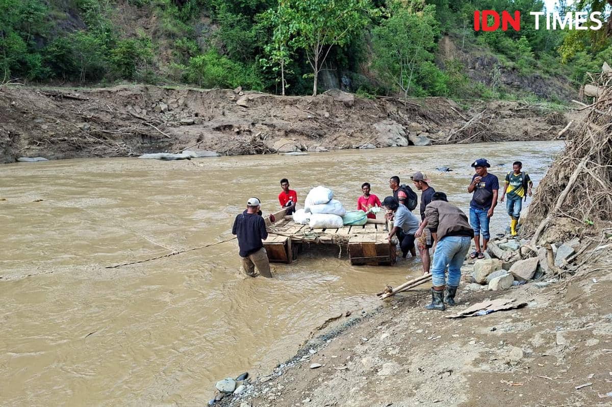 Warga Mukim Jamat menyeberang menggunakan getek karena jembatan darurat putus (IDN Times/Muhammad Saifullah)