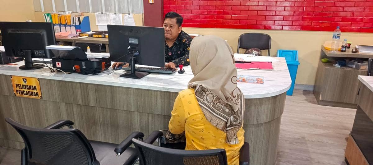 Melda Sari (49) melapor ke SPKT Polrestabes Palembang usai mengalami penganiayaan oleh keluarganya sendiri