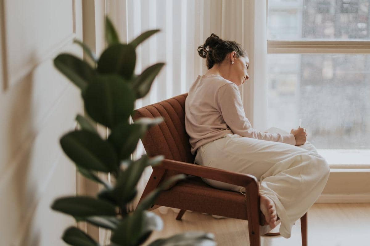 Wanita sedang duduk di kursi.