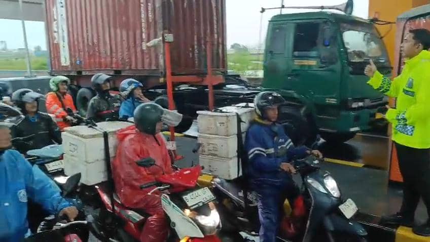 Pemotor di Bekasi dikawal polisi saat terjadi banjir. (Istimewa) 