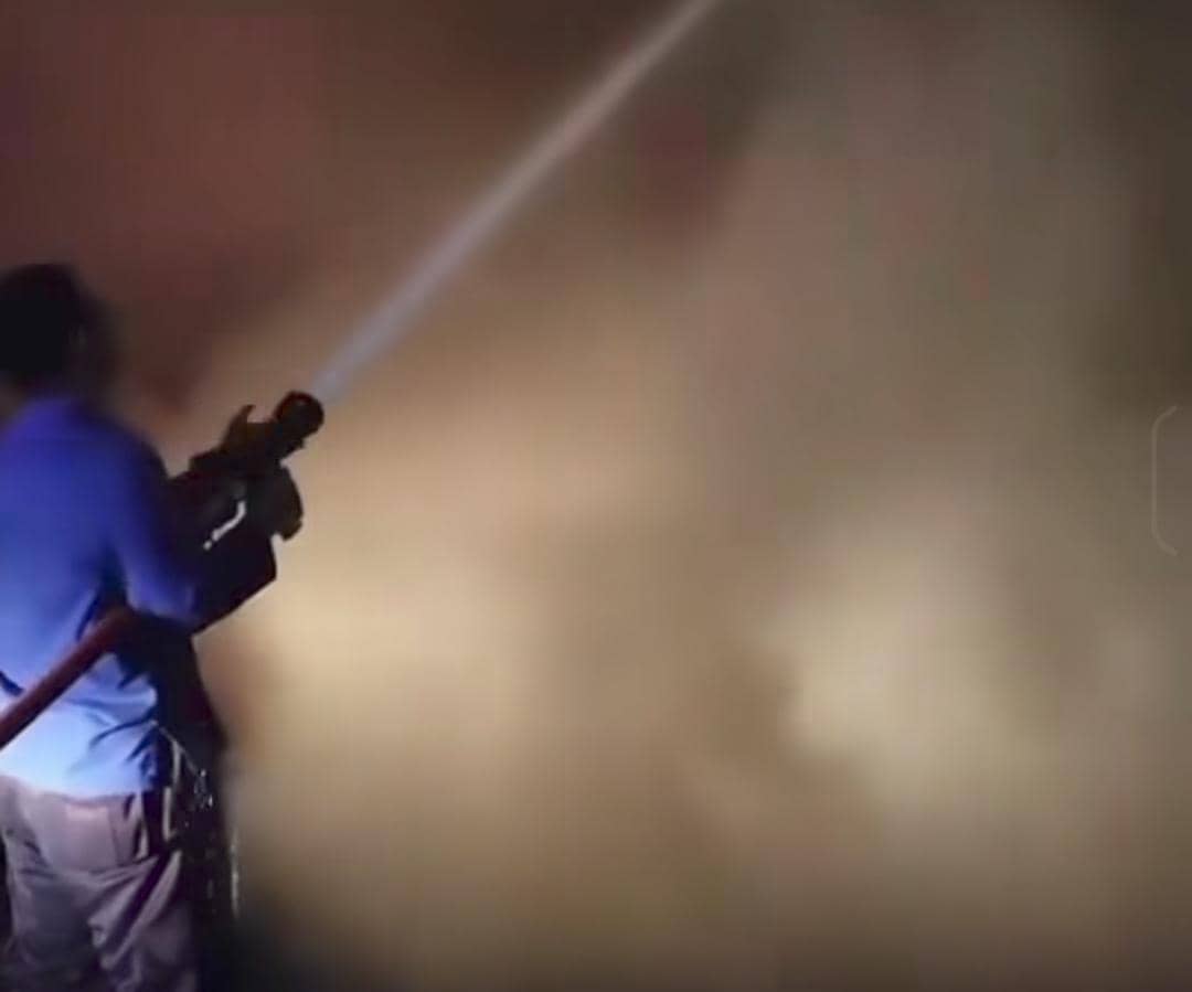 Petugas mencoba memadamkan api truk ekspedisi JNE yang terbakar di tol Palindra.