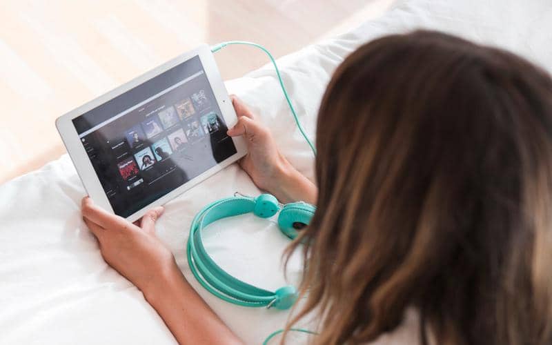 ilustrasi pengguna sedang membuka aplikasi Spotify melalui tablet