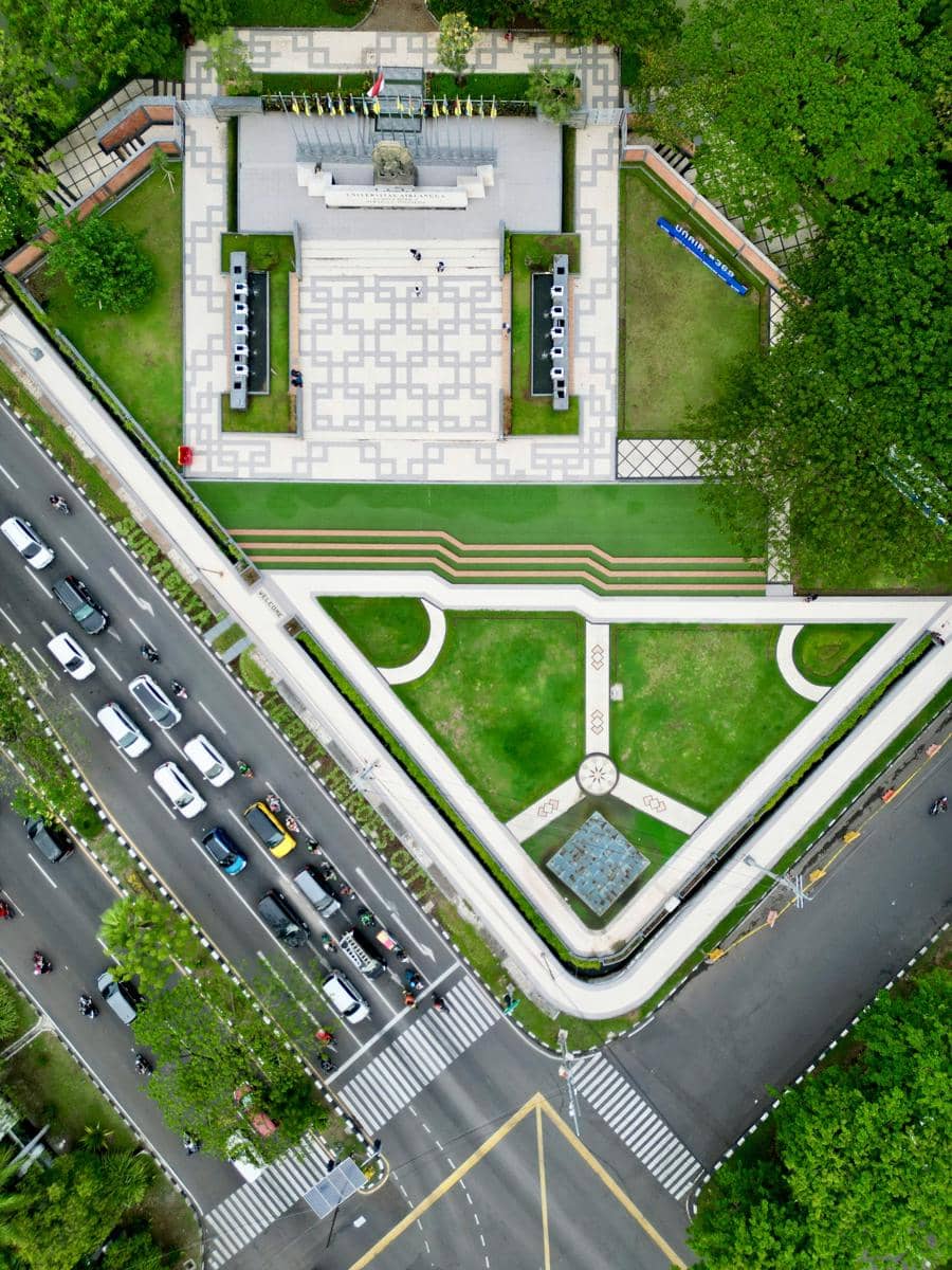 an aerial view of a park with cars parked in it Open space at Airlangga University