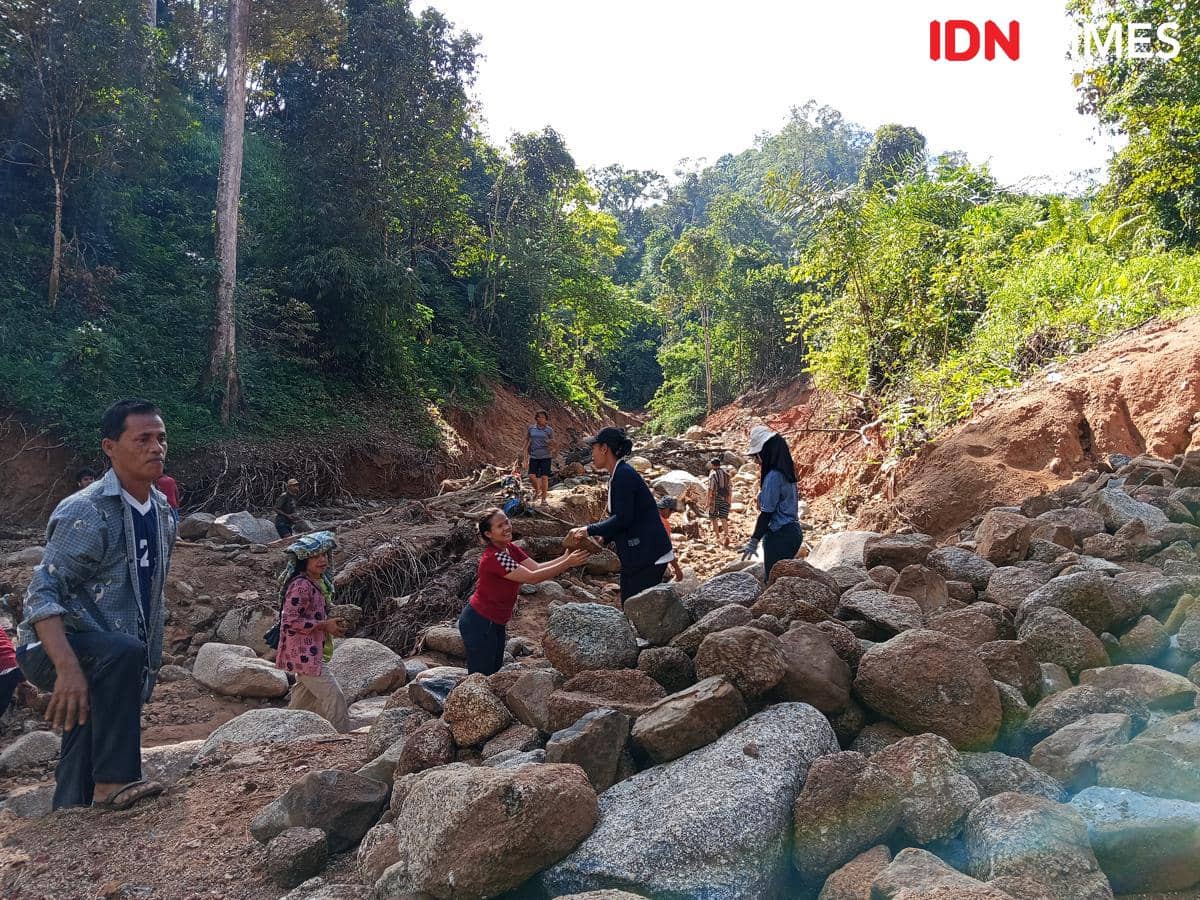 Warga Desa Sigiring-giring, Kecamatan Tukka, mengumpulkan batu untuk perbaiki akses jalan menuju desa mereka. (Foto Junaidin Zai)