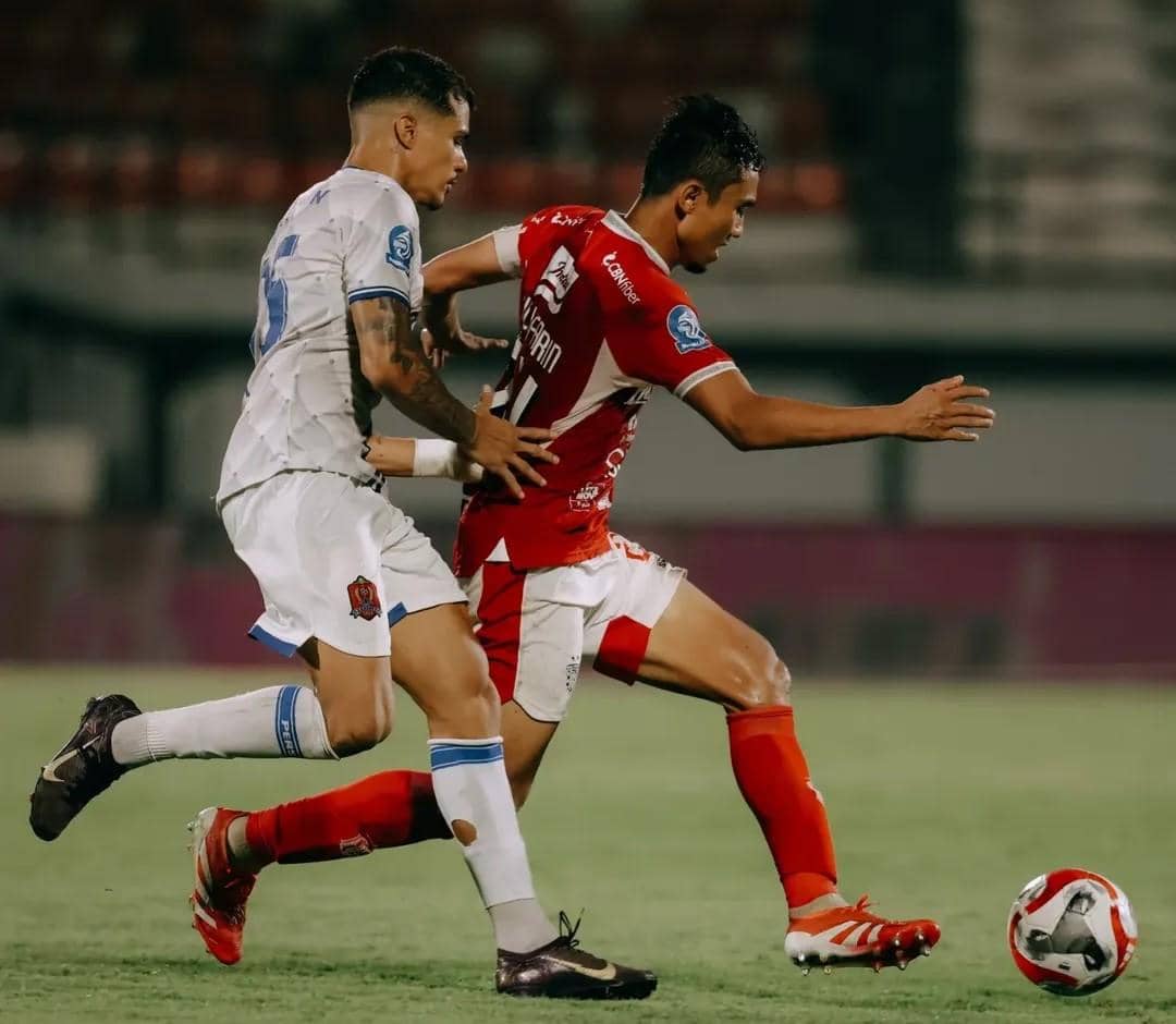 Ricky Fajrin (merah) saat berusaha melewati hadangan pemain Persijap Jepara (putih). 