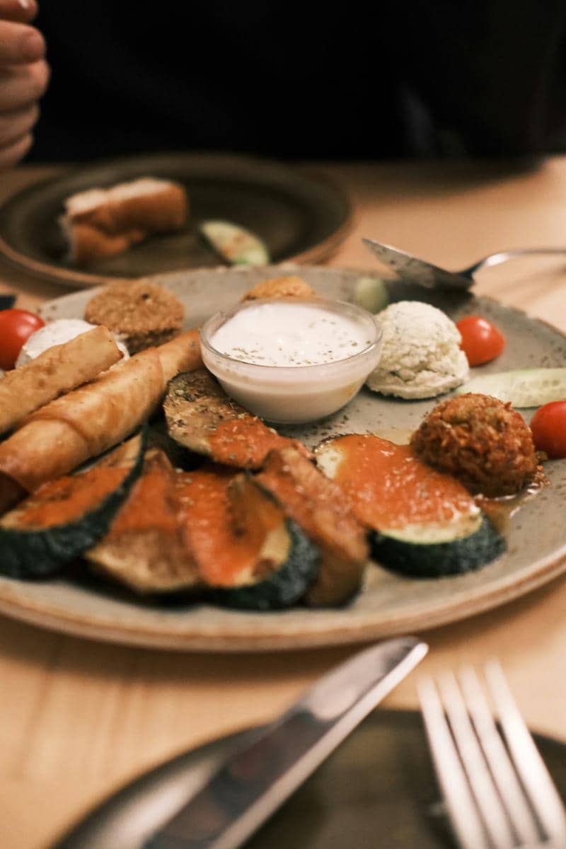 a plate of food on a table with a knife and fork