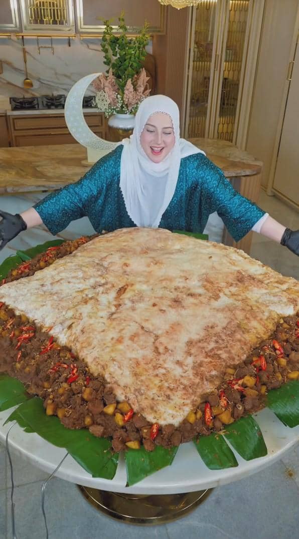 Tasyi Athasyia dalam proses pemasakan ketupat megalodon