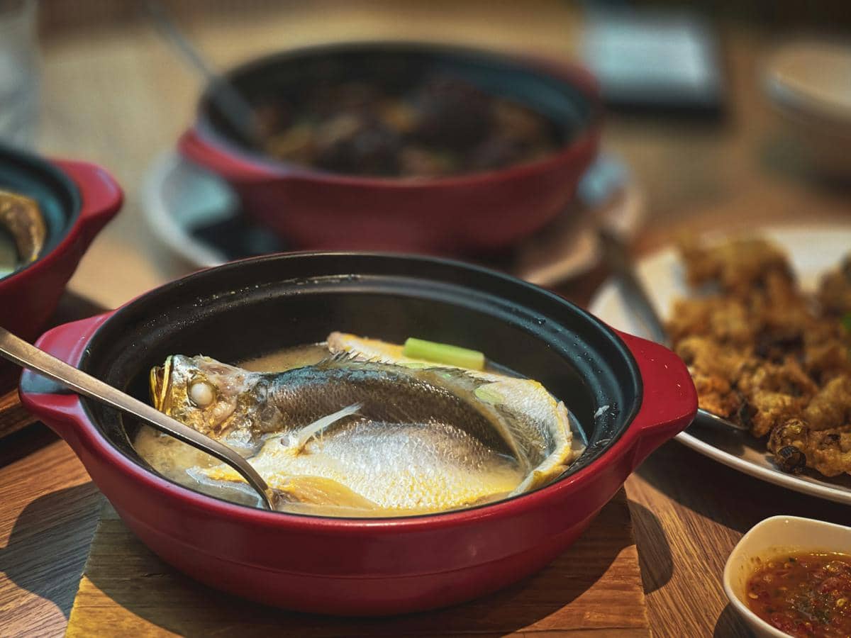  black and red ceramic bowl with food on brown wooden table