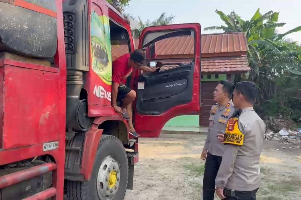 Personel Polres Muba saat menghentikan kendaraan sumbu tiga yang nekat melintas di Jalintim saat arus balik Lebaran.