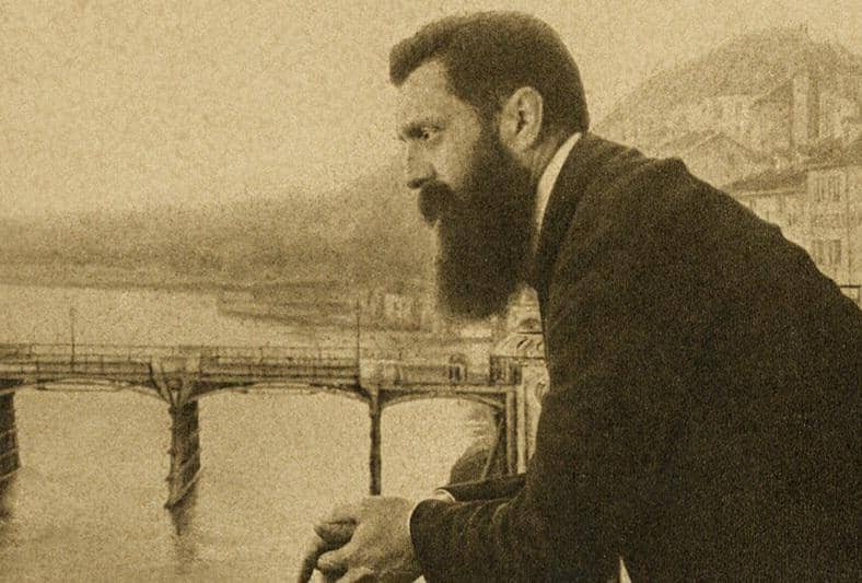 Theodor Herzl mengamati Sungai Rhine dari balkon Hotel Les Trois Rois selama Kongres Zionis Kelima pada tahun 1901 di Basel.