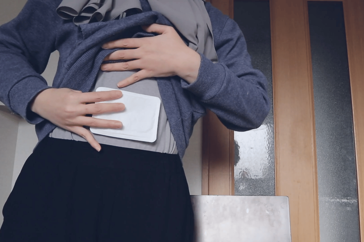 ilustrasi menempelkan heat pack di pakaian agar tubuh tetap hangat