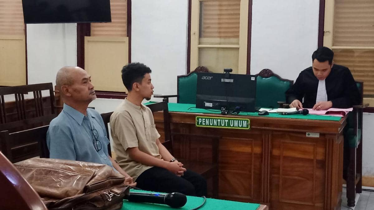 Toni Aji Anggoro, Videografer dan web desainer (baju coklat) freelance ymenjadi saksi di persidangan terdakwa Amry KS Pelawi (kiri). (Dok Adhyaksa.com)